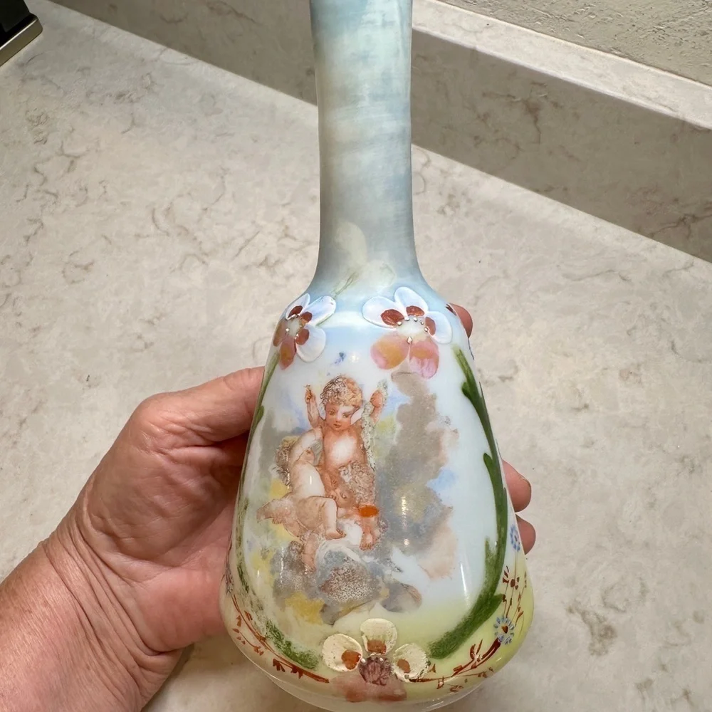ANTIQUE BARBER SHOP BOTTLE WITH ATTRACTIVE CHERUB PICTURED ON FRONT SIDE.